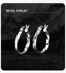 Close-up of S925 sterling silver Mobius hoop earrings with a polished mirror finish.