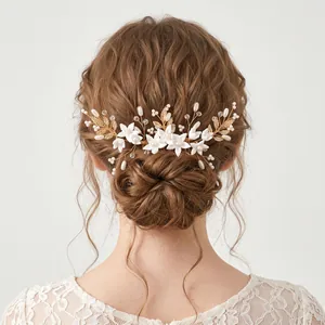 Detailed view of forest-style handmade bridal hair comb with white flowers and pearls