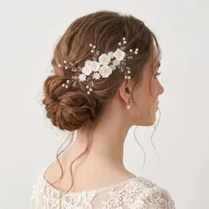 Handmade bridal hair comb with white clay flowers and elegant pearls for wedding