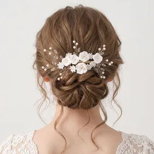 Elegant handmade forest style bridal hair comb with white clay flowers and pearls for weddings