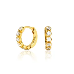 Detailed macro view of S925 sterling silver gold-plated hoop earrings with cubic zirconia