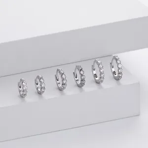 Row of S925 sterling silver hoop earrings with sparkling cubic zirconia in various sizes