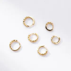 Close-up of gold-plated S925 silver hoop earrings featuring sparkling pave zircons.
