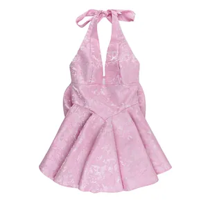 Elegant pink jacquard halter dress with open back and large bow tie detail for party