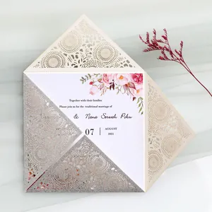 Detailed view of laser-cut wedding invitation with glitter finish and floral print