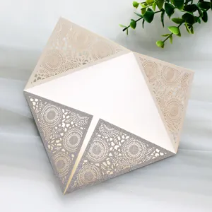 Detail showing intricate laser-cut sunflower pattern on glittery wedding invitation