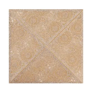 Close-up detail of laser-cut wedding invitation card with gold glitter floral pattern texture