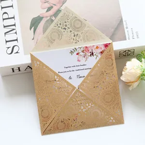 Detailed view of luxury laser-cut gold glitter wedding invitation with floral printed insert