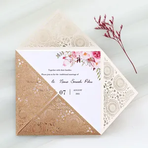 Detail view of gold glitter laser-cut wedding invitation with delicate lace pattern