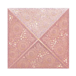 Detailed close-up of pink glitter laser-cut lace pattern on a square invitation card