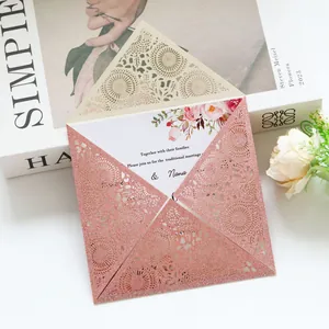 Macro detail of a rose gold glitter laser-cut wedding invitation with elegant floral card.