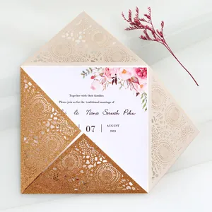 Detailed view of elegant gold glitter laser-cut floral lace wedding invitation.