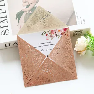 Detail view of rose gold glitter laser-cut wedding invitation with floral insert