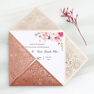 Detailed view of rose gold glitter laser-cut wedding invitation with floral inner card