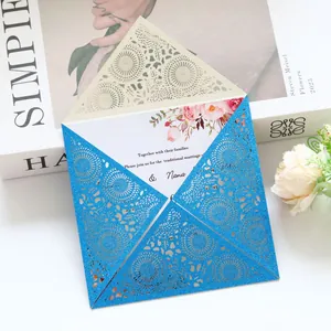 Detail of blue glitter laser-cut wedding invitation featuring elegant lace floral patterns.