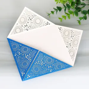 Detailed view of elegant blue glitter laser-cut wedding invitation with lace patterns
