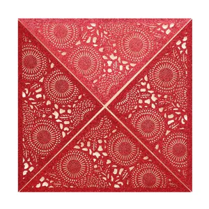 Detailed close-up of red laser-cut glitter wedding invitation with floral patterns