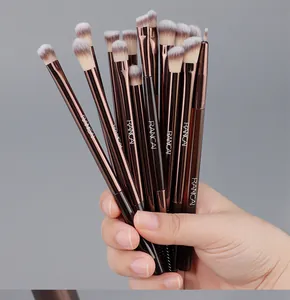 A detailed close-up showing a 15-piece professional eye makeup brush set held in a hand.