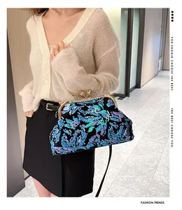 Detailed shot of sequined evening bag being held by a model in a stylish indoor environment