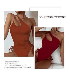 Detail view of a sexy one-shoulder one-piece swimsuit featuring front cutout and side tie-ups