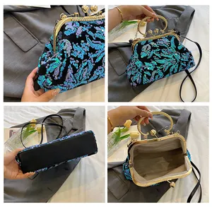 Detailed close-up view of sequined evening clutch bag with gold handle and metal frame