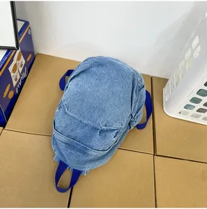 Primer plano de mochila de mezclilla lavada retro con correas de cincha azules duraderas