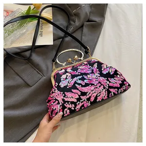 Detail view of colorful sequin evening bag with vintage gold handle and black strap