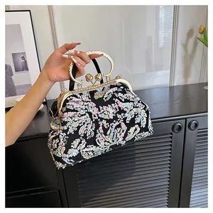 Detailed view of handmade colorful sequin evening bag with elegant gold metal frame