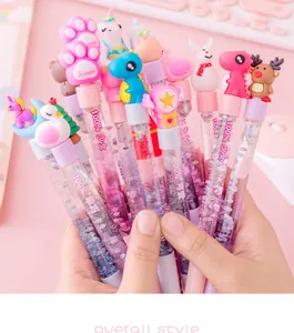 Detailed view of colorful cartoon quicksand pens with glitter and unicorn toppers