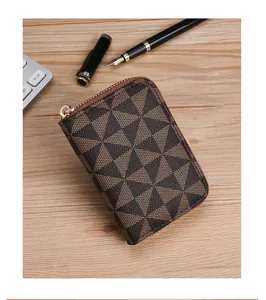 Close-up of brown geometric pattern card holder on wooden desk with office pens