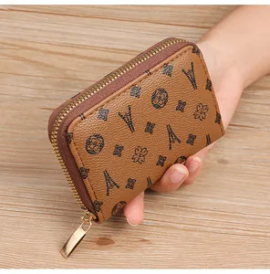 Detail shot of a brown RFID anti-degaussing card holder with Eiffel Tower pattern.