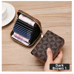 Macro detail of brown accordion zip-around card wallet with geometric triangle pattern