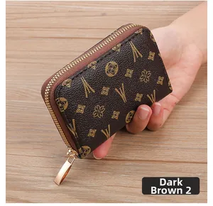 Close-up of a dark brown zip-around card holder with vintage Eiffel Tower patterns