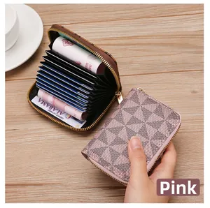 Detail of pink zip card holder with geometric star pattern shown in hand