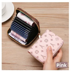 Detail view of pink card holder with Eiffel Tower pattern and multi-card interior