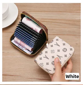 White zip-around accordion card holder with Eiffel Tower pattern and multi-slots