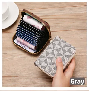 Detailed macro view of gray checkered card wallet with multiple interior slots