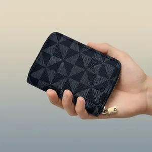 Close-up of slim geometric pattern card holder held in hand against gradient background