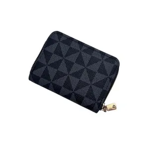Close-up of grey geometric triangle pattern and gold zipper on a slim card holder
