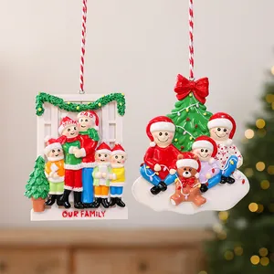 Detailed view of two resin Christmas ornaments featuring family members in festive hats