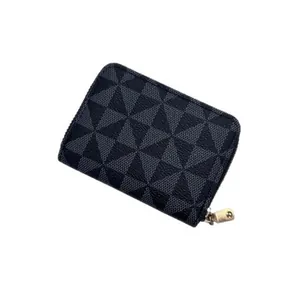 Compact women's card wallet with black geometric pattern and secure zipper closure