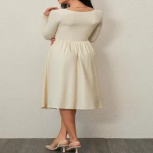 Back view of a long-sleeved cream pleated dress for women with elegant drape detail