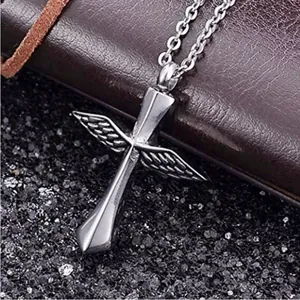 Macro view of silver winged cross pendant necklace with screw top for cremation urn