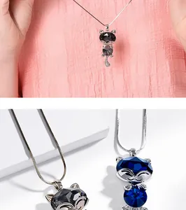 Detailed view of fox shaped crystal pendant necklace in blue and grey with silver chain
