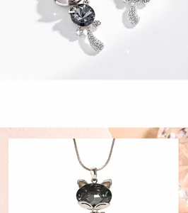 Detail view of cat head necklace pendant with dark grey faceted crystal and rose gold chain