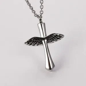 Macro detail of polished stainless steel wings and cross cremation urn pendant necklace
