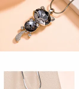 Close-up detail of a charming cat-shaped crystal pendant with exquisite metallic luster.