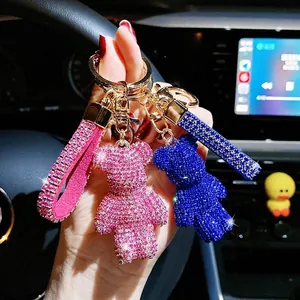 Detailed view of sparkling pink and blue rhinestone bear keychains for car accessories