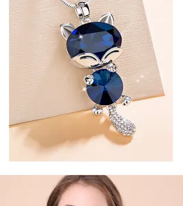 Close-up view of an elegant cat-shaped pendant with deep blue crystals and silver-tone chain