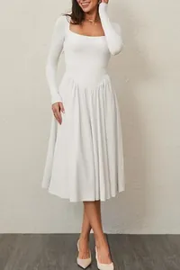 Elegant white long-sleeve dress with square neck and pleated skirt in a detail view